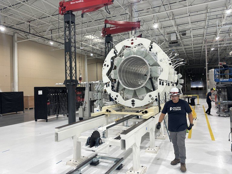 A worker walks by a giant capacitor being built to deliver massive electrical pulses to hydrogen-fuel targets.