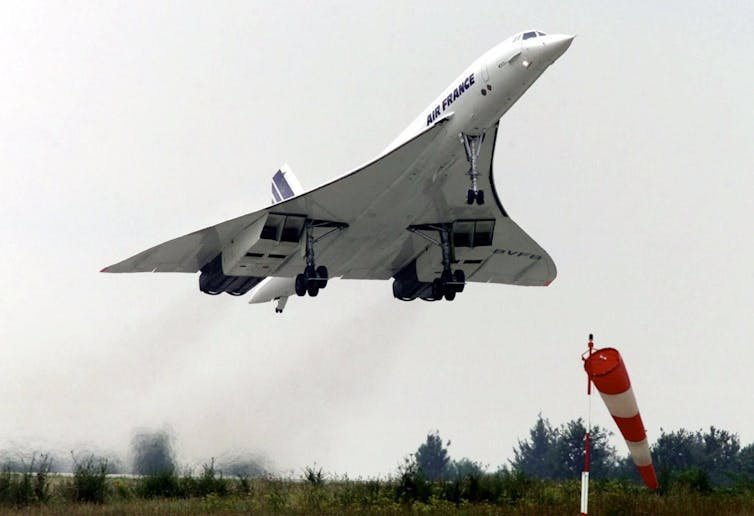 A photo showing a jet with a triangular shape taking off