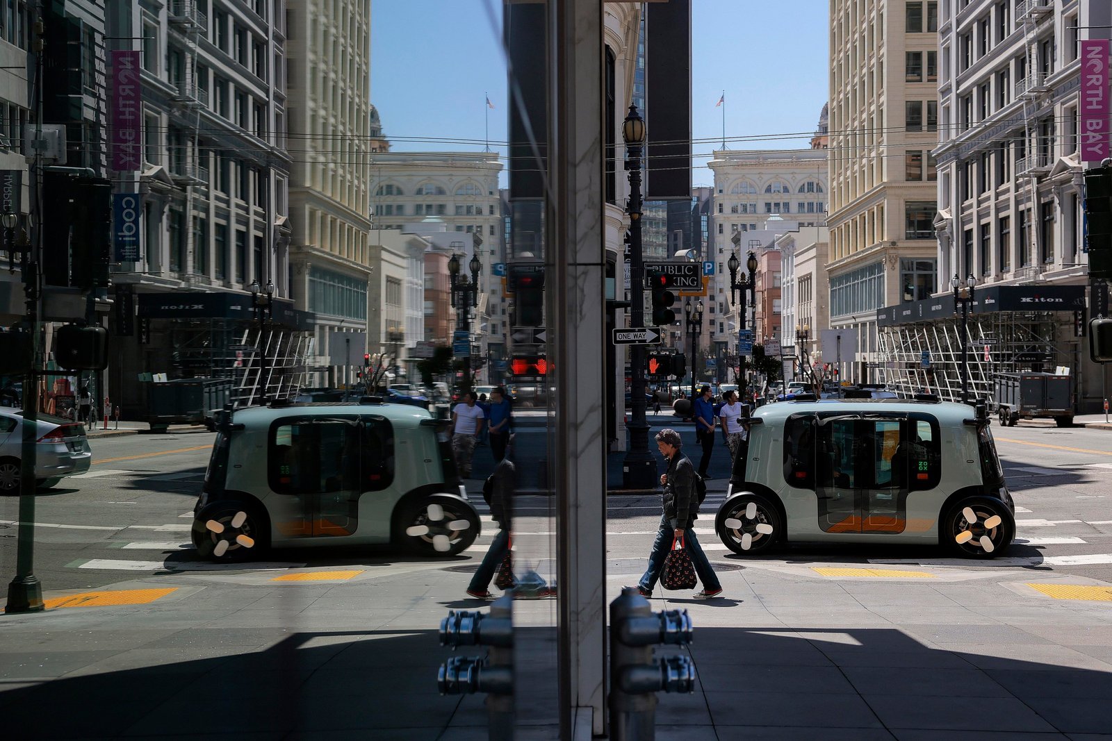 An Amazon-owned Zoox driverless robotaxi drives down a street on August 3rd in San Francisco. The National Highway Traffic Safety ‌Administration cleared Amazon-owned Zoox robotaxis to charge customers for robotaxi rides.