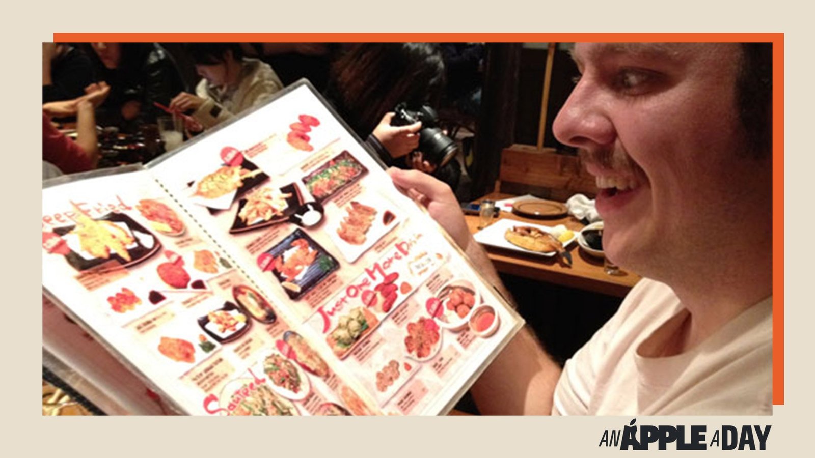 A person holding a menu in a restaurant shot on iPhone 4S