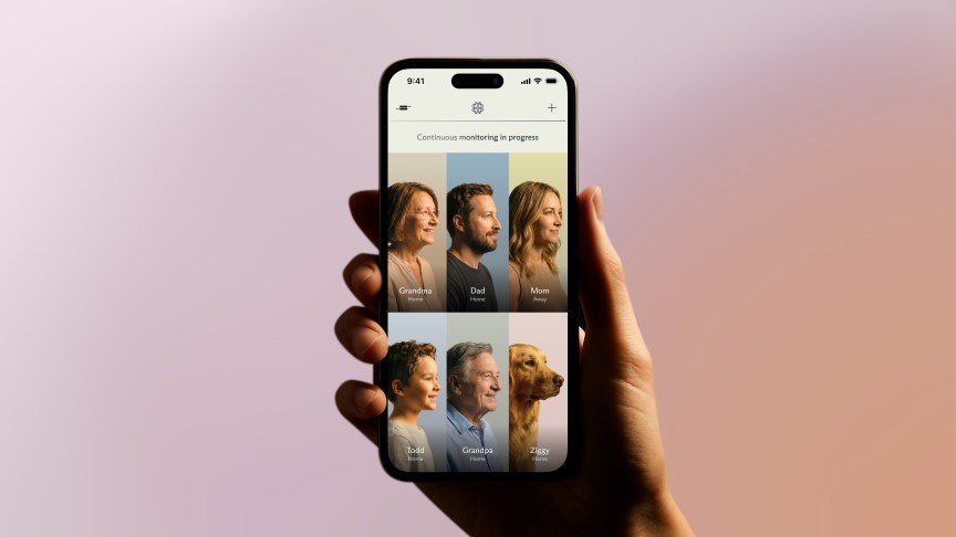 A hand holding a phone showing different family members on the Luffu app.
