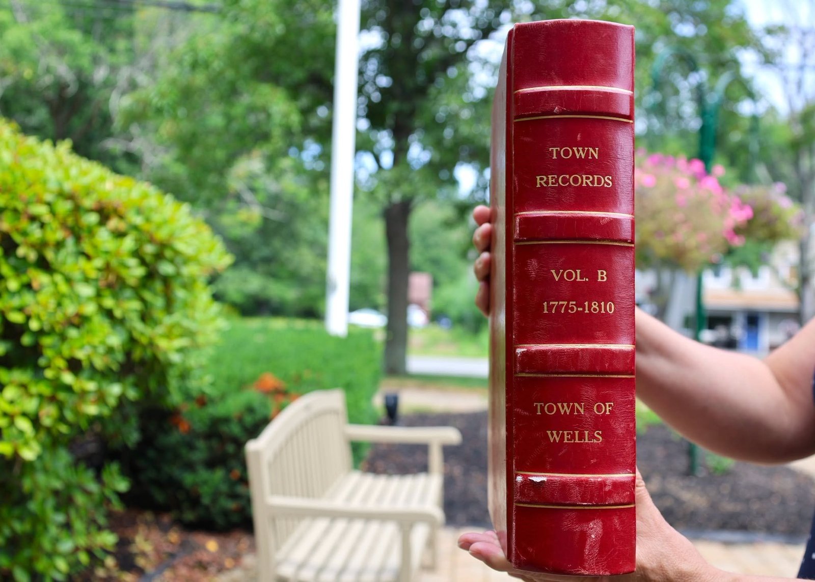 a red book with town records, volumb b 1775-1810, town of wells written on the spine