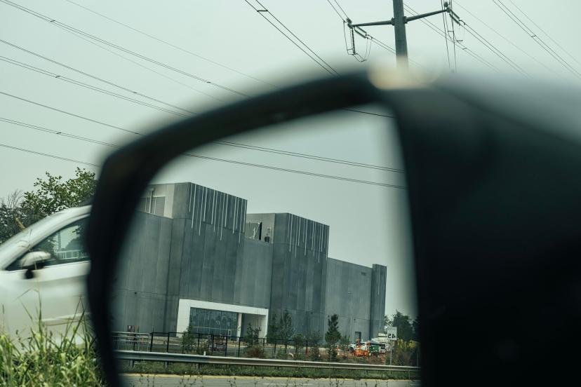 A data center viewed in a side mirror of a car in Ashburn, Virginia.