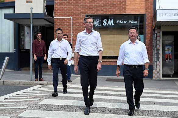Former premier Dominic Perrottet (centre) campaigning in Peakhurst with Mark Coure (right) in March 2023.