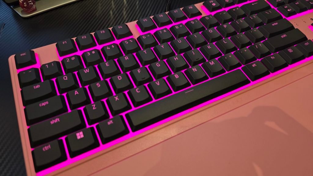 Top angle shot of the keyboard showing the beautiful pink lighting and wrist rest.