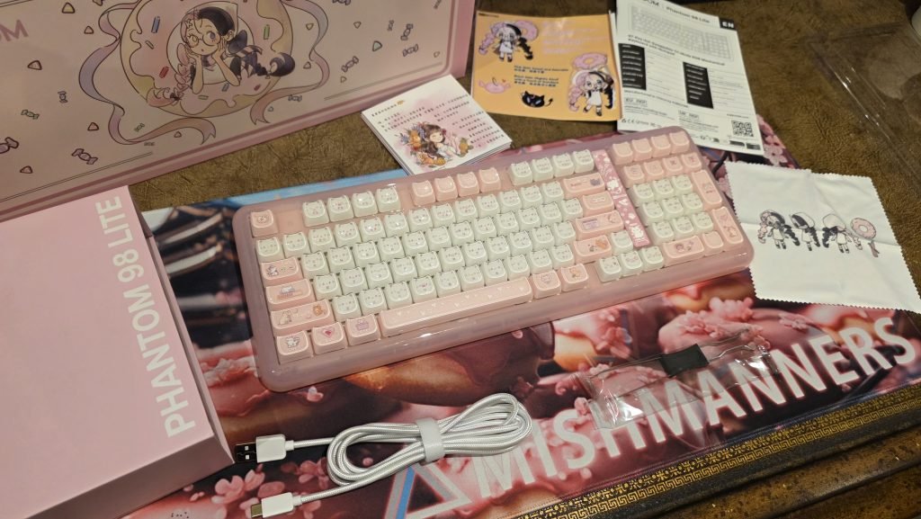 Out of the box you receive the keyboard, keycap puller, white cable, cute dust cloth, and cute booklet showing anime vibes.