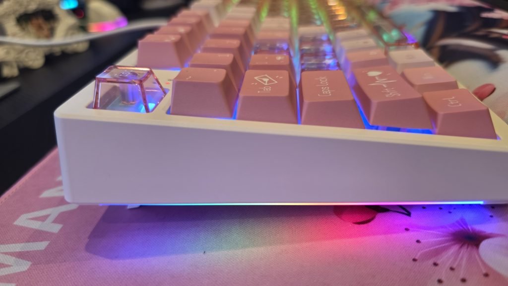 Side profile of the keyboard showing the slightly different sized keycaps and also the kickstand is open.