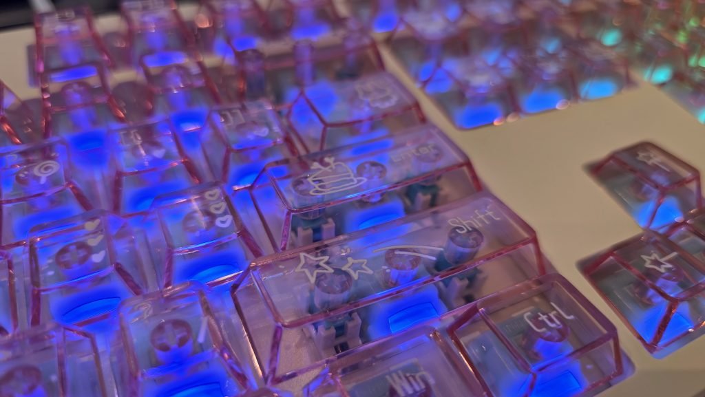 Close up of the right hand side of the keyboard showing a blue light coming through the keys.