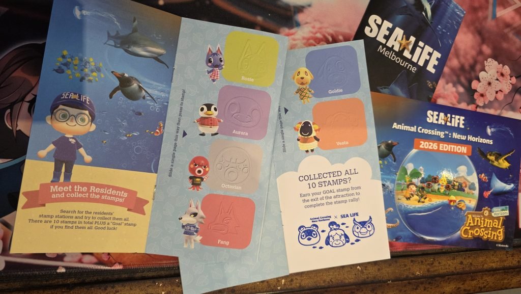 Completed Stamp rally form showing the stamp that you get for completing it and the postcard. Both are Animal Crossing themed.