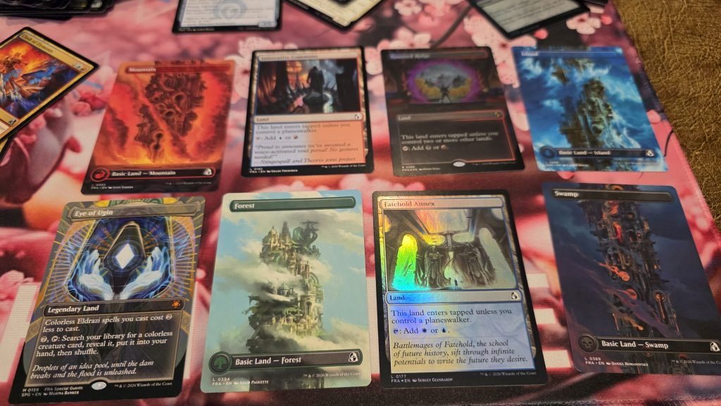 eight land cards showing various cards in borderless artwork, fractured artwork, dual mana, and some foil cards.