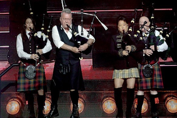 Jimmy and Jane Barnes on stage with bag pipes.