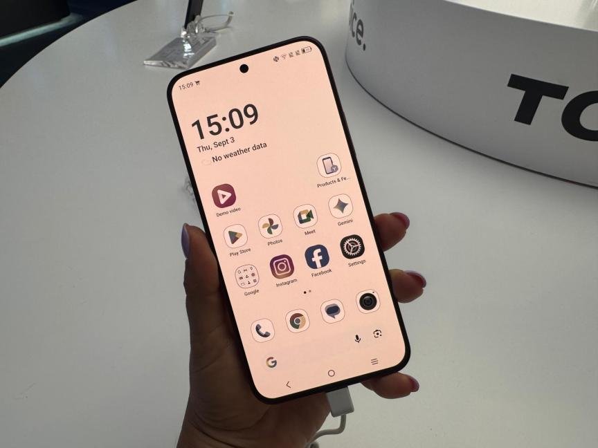 Image of a hand holding a TCL phone
