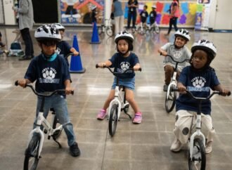 A childhood rite moves indoors as kindergartners learn to ride bikes in school gyms