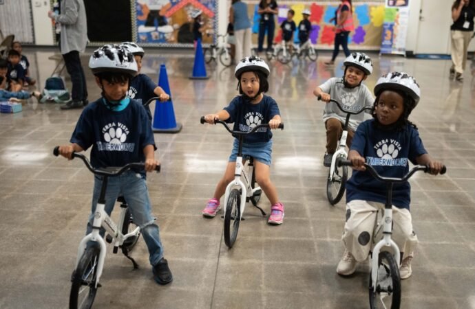 A childhood rite moves indoors as kindergartners learn to ride bikes in school gyms