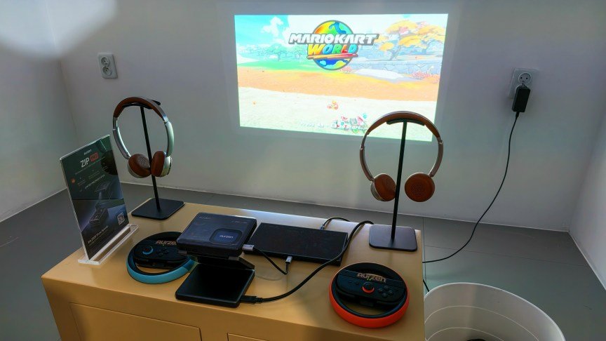 The Aurzen Zip Pro with controllers and headphones projecting Mario Kart World.
