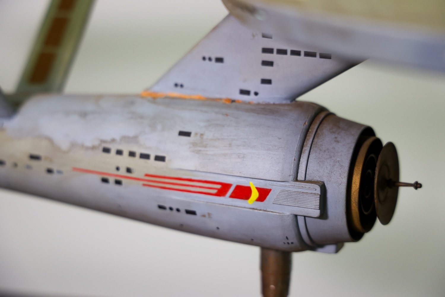 Close up of USS Enterprise model base showing wear and tear
