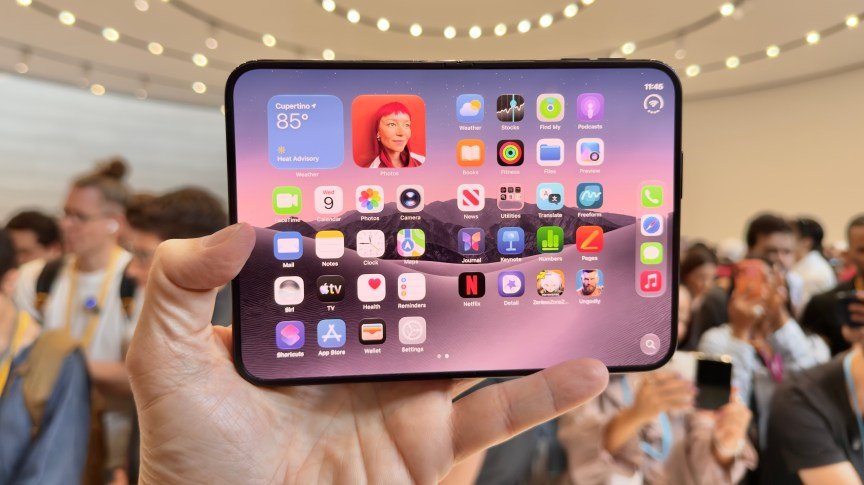A hand holding the iPhone Duo with the screen open