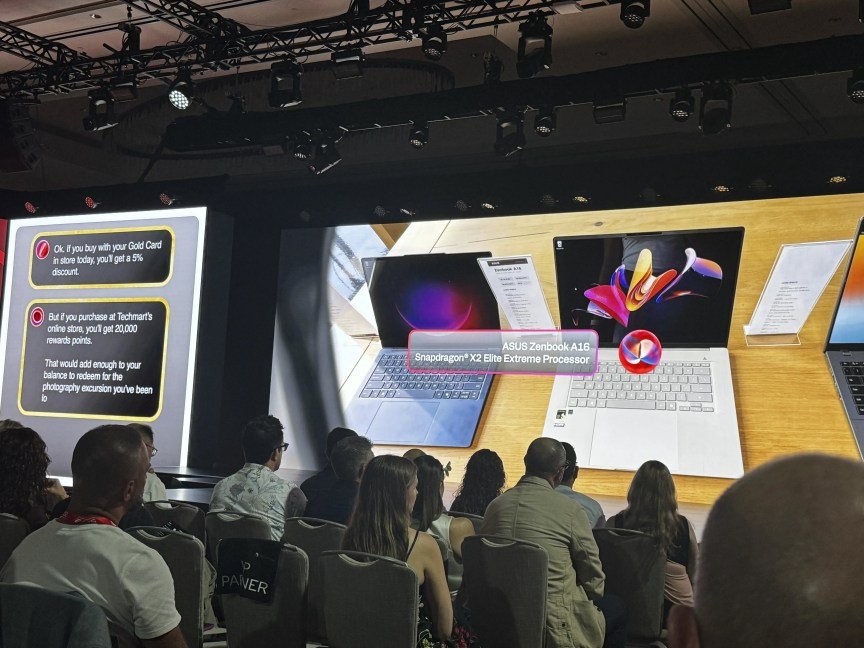 People sit in front of a presentation simulating an AI agent making purchases based on what is seen through smart glasses.