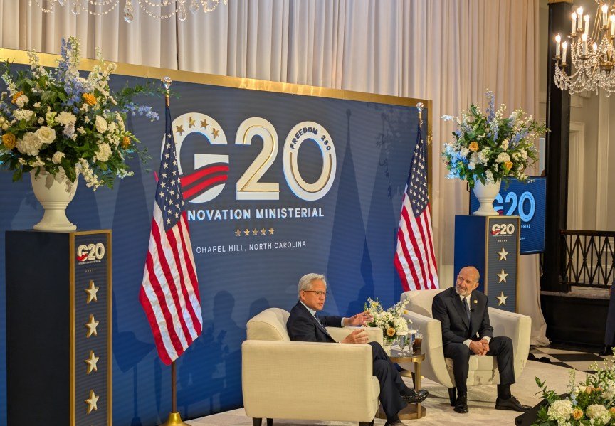 Jensen Huang on stage with Howard Lutnick at the G20 forum