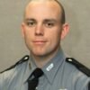 Man charged in the fatal shooting of Kentucky state trooper was wanted on a parole violation