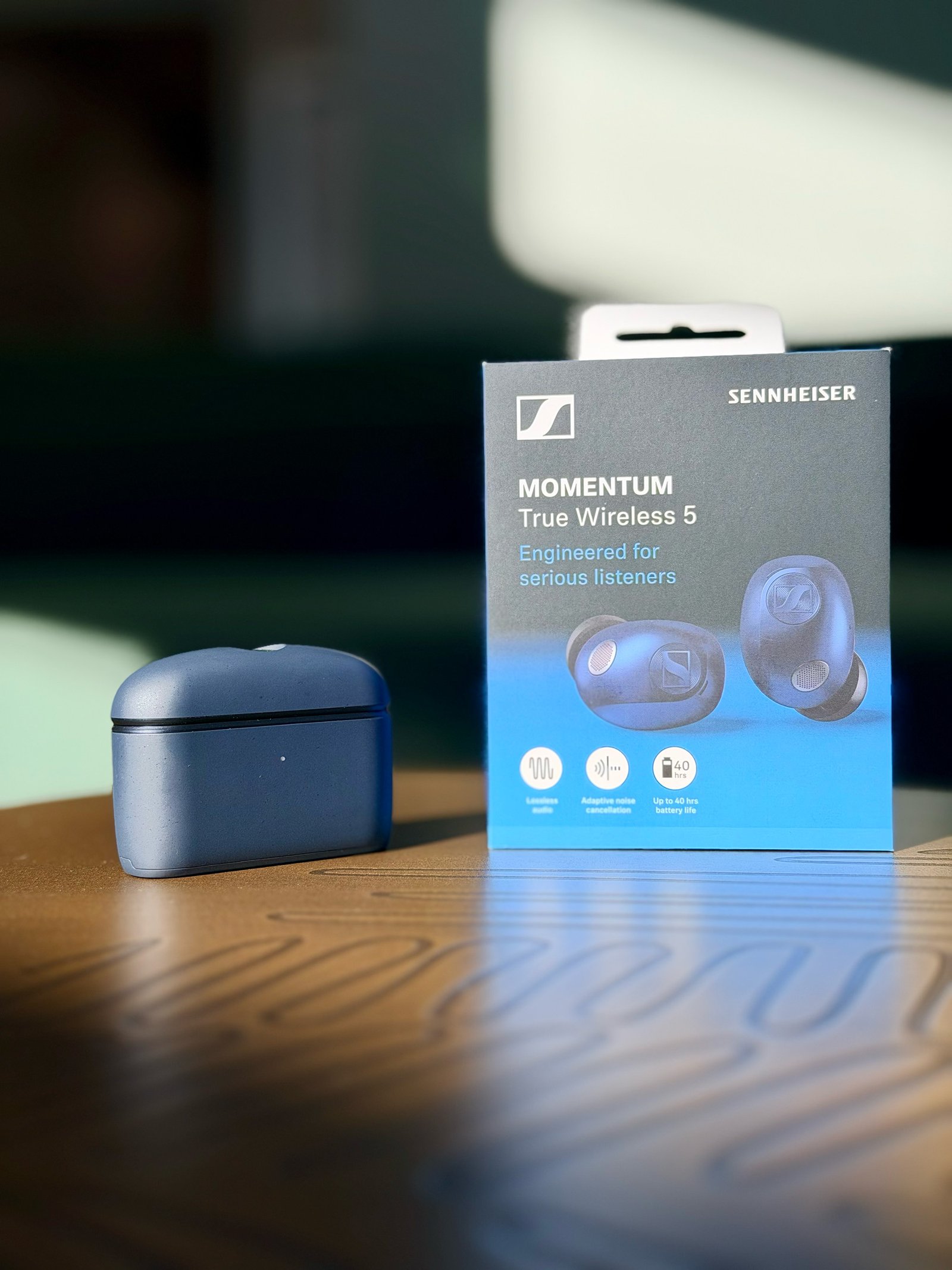 The Sennheiser MTW5 earbuds + case on a table
