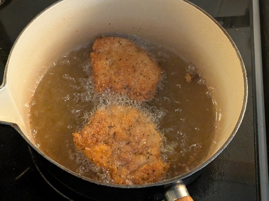 chicken cutlets in pot of oil