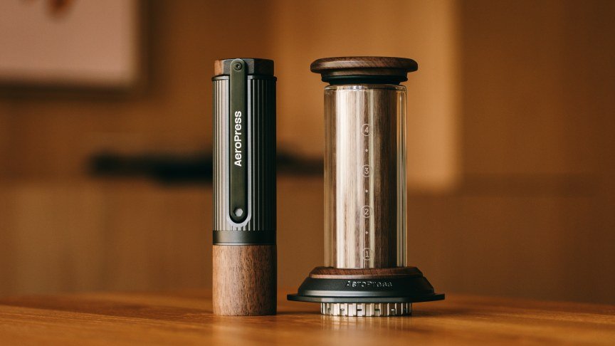 A walnut AeroPress brewer and grinder.