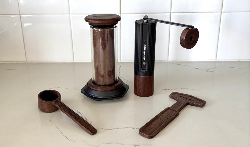 The AeroPress walnut brewer, grinder, scoop and stir.