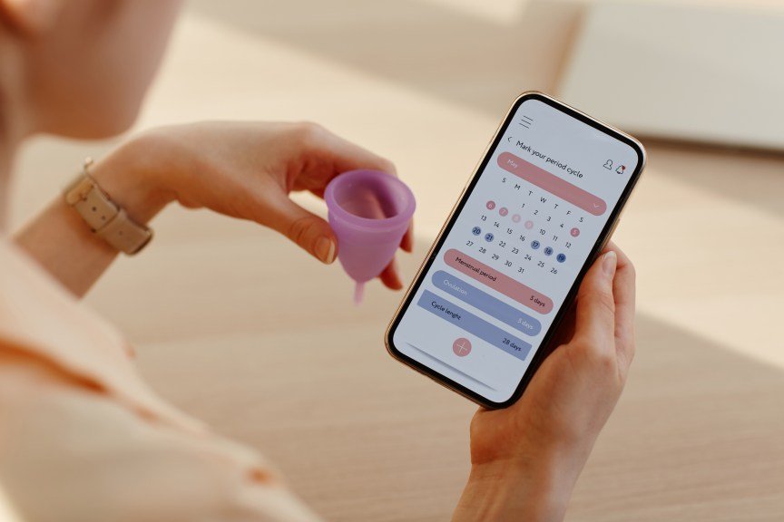 Close up of a person calculating their menstrual cycle using an app calendar.