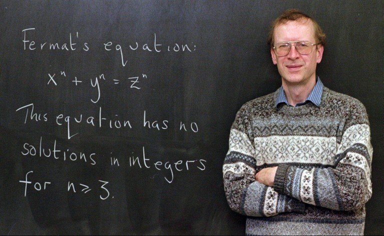 Andrew John Wiles poses next to Fermat's Last Theorem, written on a chalkboard in his Princeton university office in 1998.
