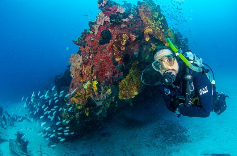 Biologist Guilherme Longo scuba diving close to a restored outcrop of coral reef.