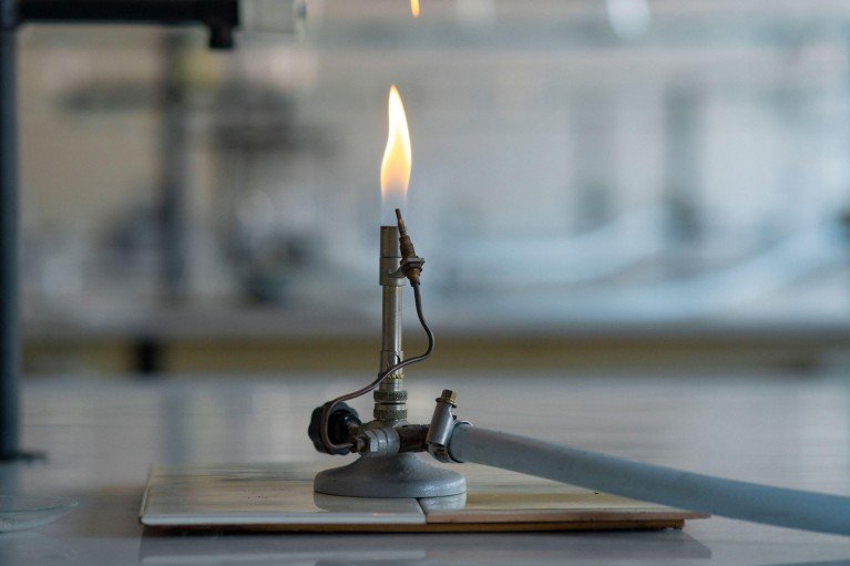 A lit bunsen burner in a laboratory.