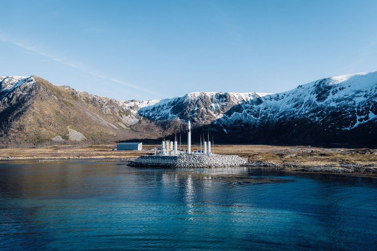 The Spectrum rocket sits on its launch pad in Andøya Spaceport in Norway ringed by snow-topped mountains.