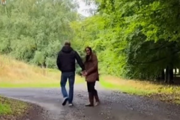 Meghan and Harry walk through woodland in one of the scenes from the Instagram clip. 
