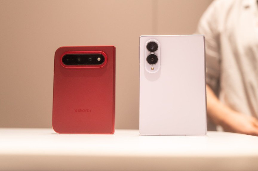 A Xiaomi foldable phone next to a Samsung foldable phone.