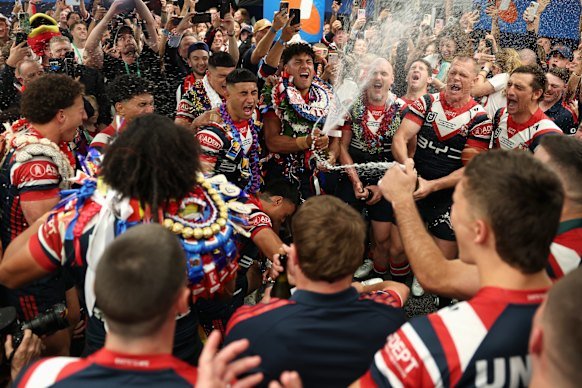 Roosters players celebrate their grand final win on Sunday night.