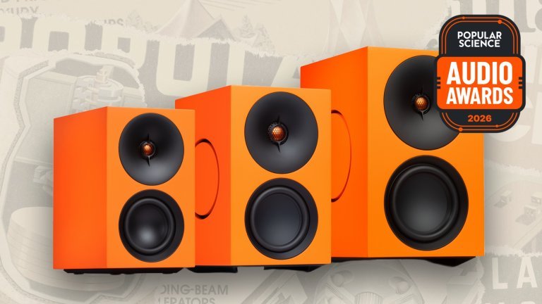 Cambridge Audio L/R series powered speakers in orange, lined up from smallest to largest