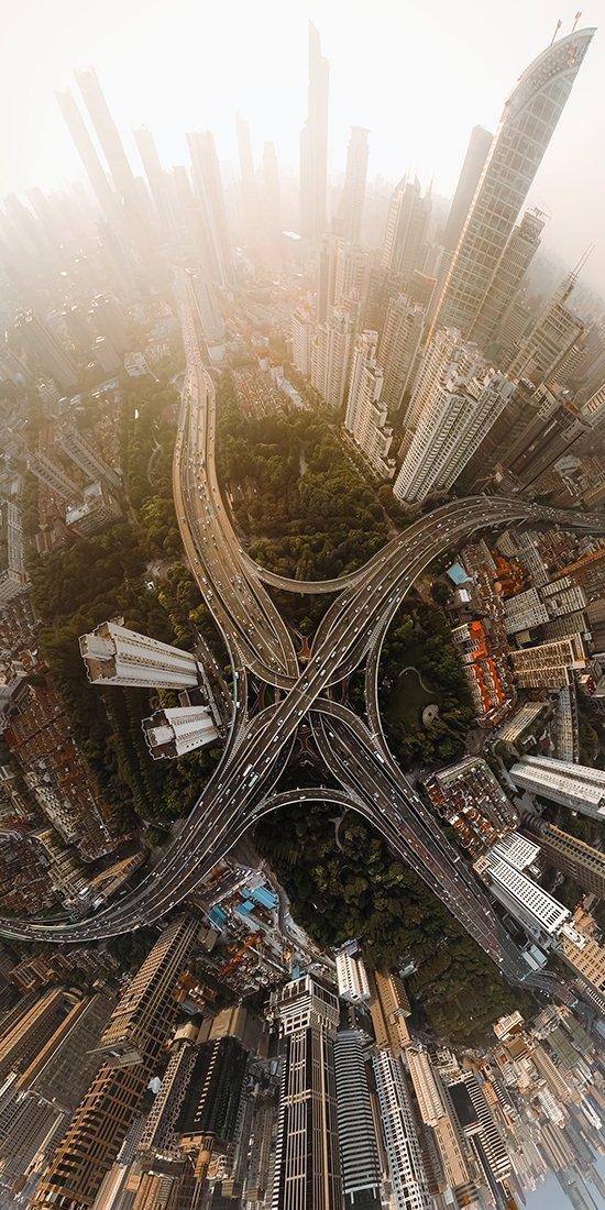 road meets in an x pattern in middle of urban area