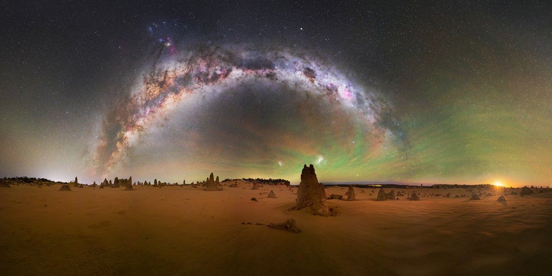 milky way over desert landscape