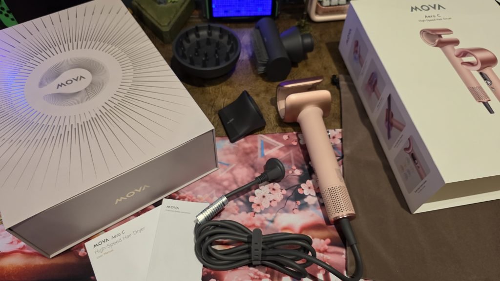 Mova Aero C hairdryer in light pink showing the three attachments, manual, and plush bag. The box itself is solid, rigid, and high quality.