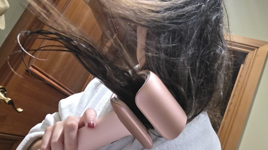 me holding the hairdryer whilst drying my hair and a chunk of my hair is in the middle of the barrel of the hairdryer and the rest of my hair is flying around.