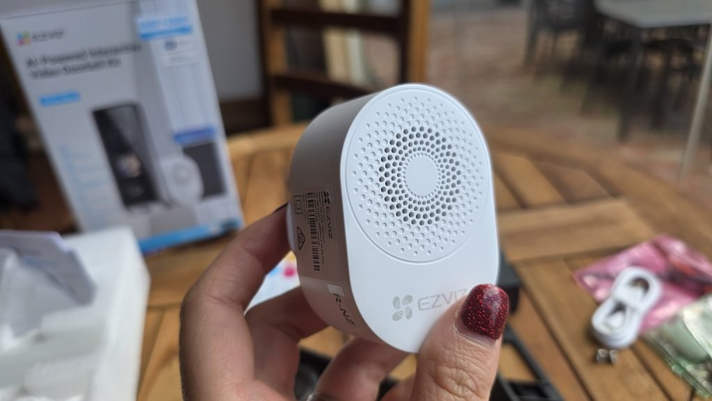 Close up of the included chime. It's small, fitting in my hand and has a small speaker on the front for the sound.
