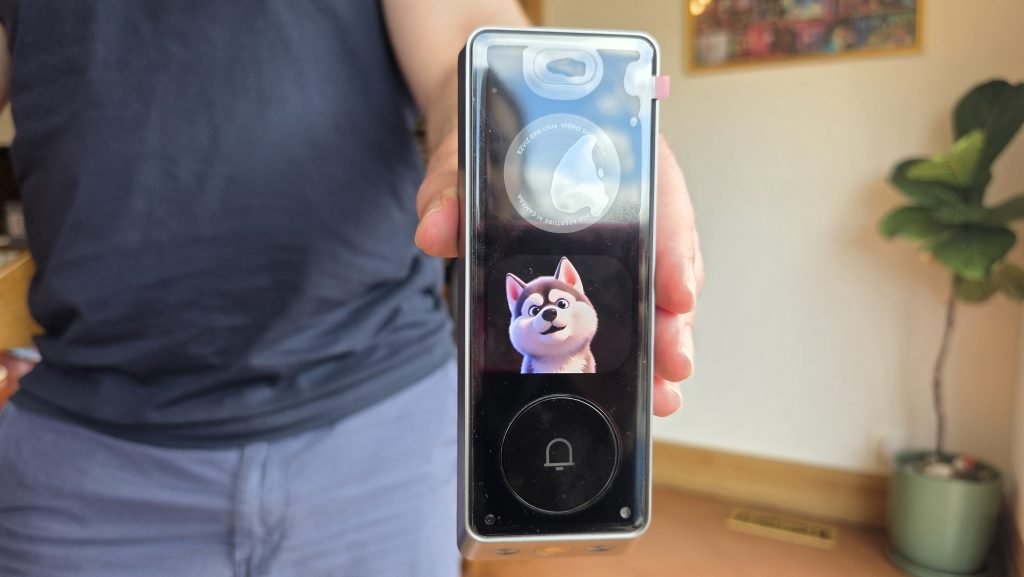 Doorbell camera showing a cute 3D animation of a husky on the screen.