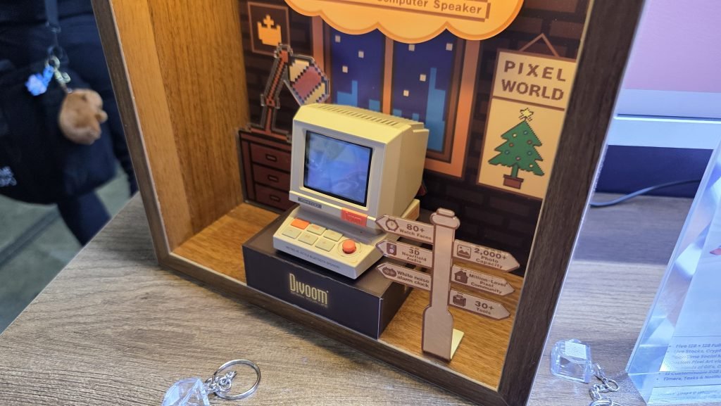 Old retro style computer looking speaker, like the old big boxy monitors from the 90s. It has the old grey monitor colour, and some highlighted orange buttons.