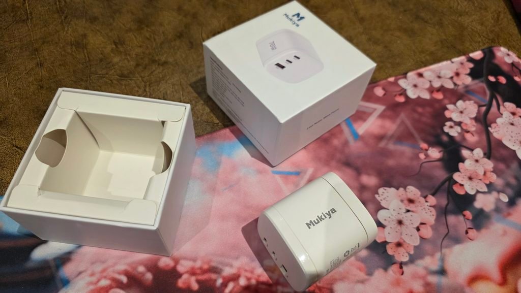Small box with the charger next to it. It's only in white.