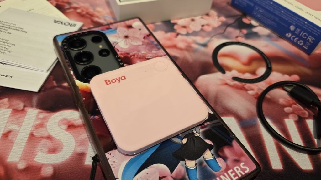 The BOYA AI note taker is snapped on the back of a Samsung note case.