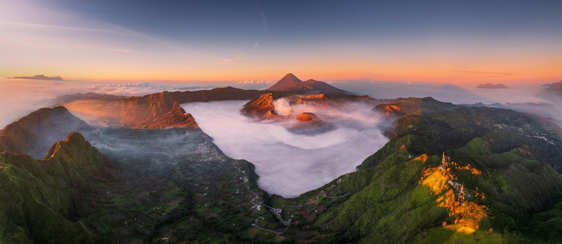 volcano filled with clouds at golden hour