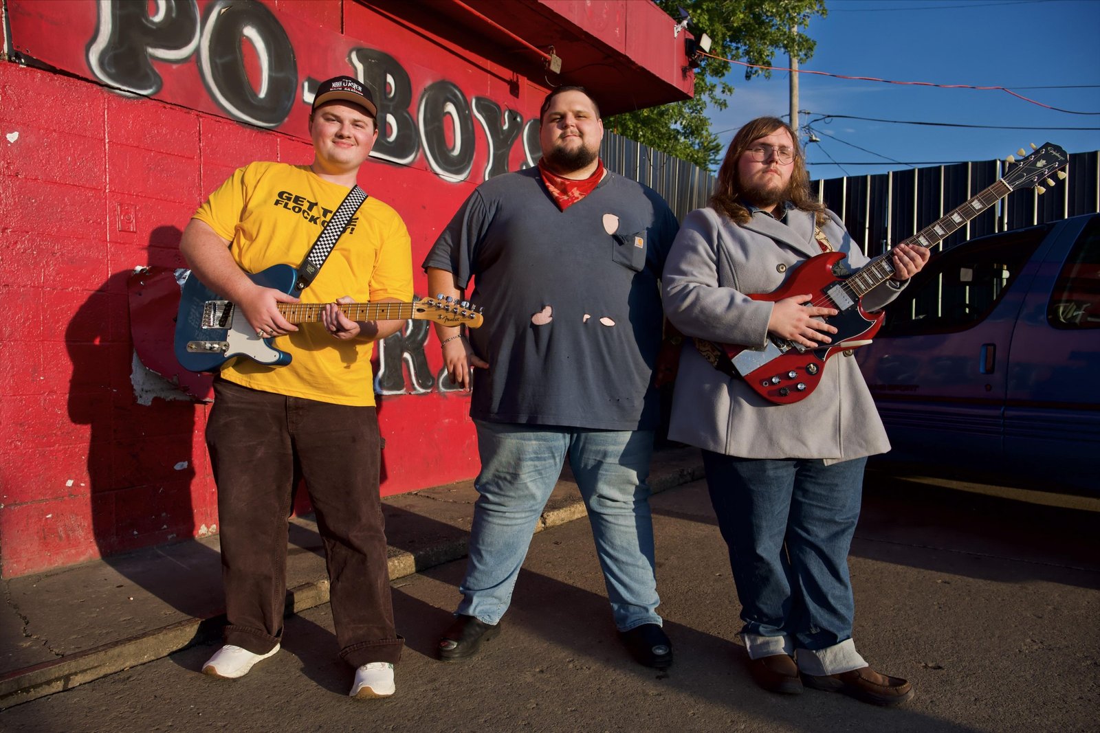 Noah Jasper Gibson, Michael “Roofus” Riley Jenkins, and Bobby Adkins III pose with their guitars.