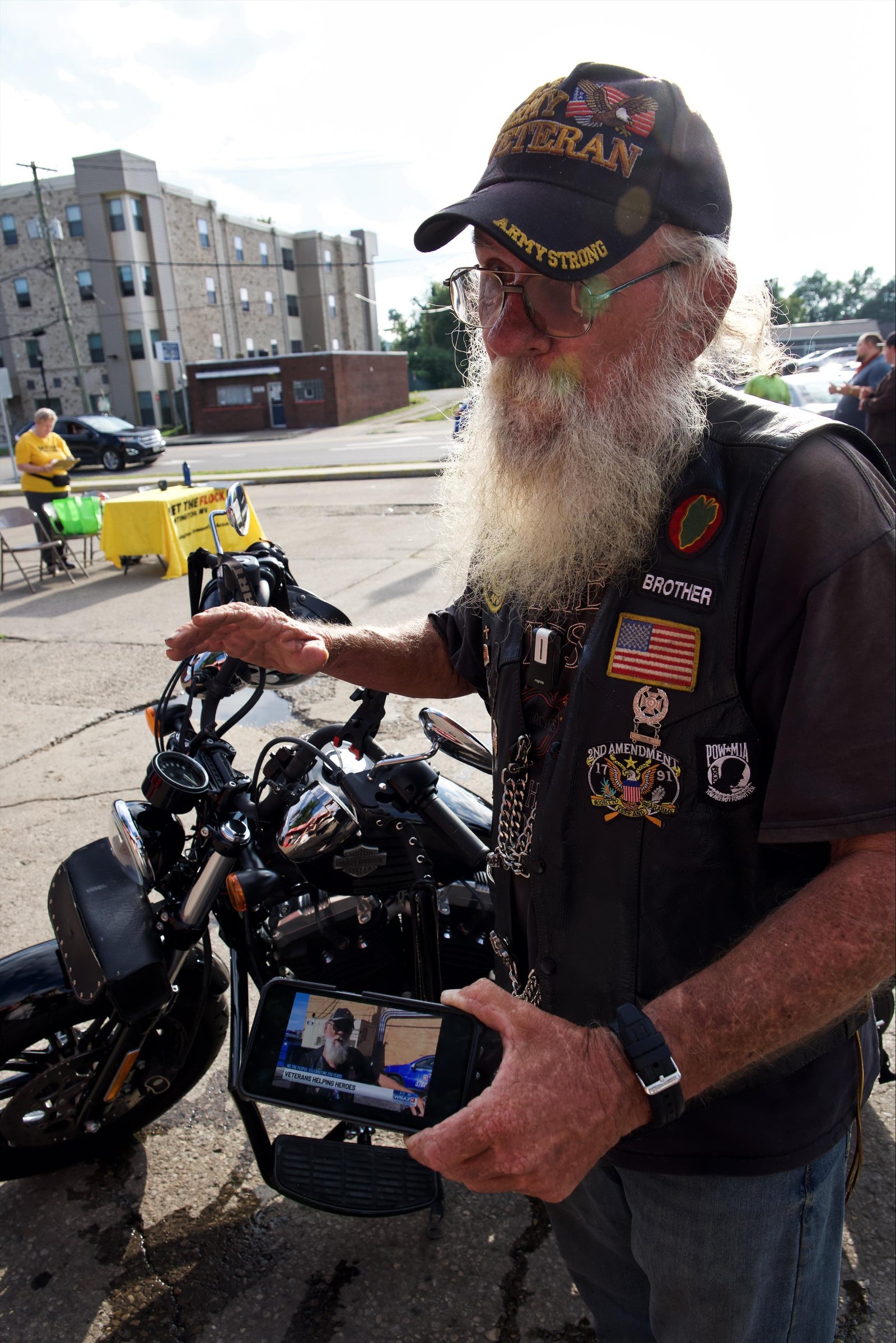 Dennis Gibson showing reporter a video done by local news crew, interviewing him about Veteran’s Helping Heroes.