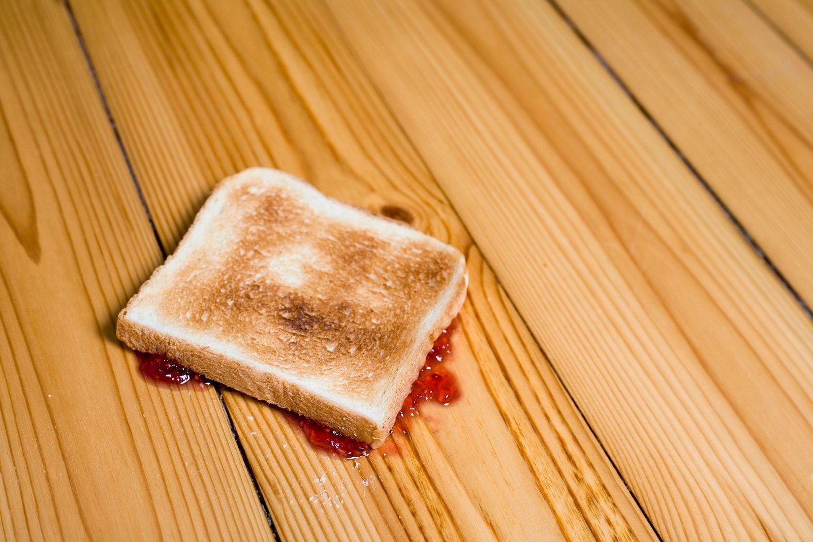 bread with jam on a wooden floor